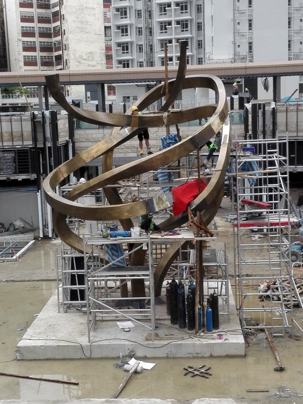 Ribbon-like sculpture nearing completion on its foundation