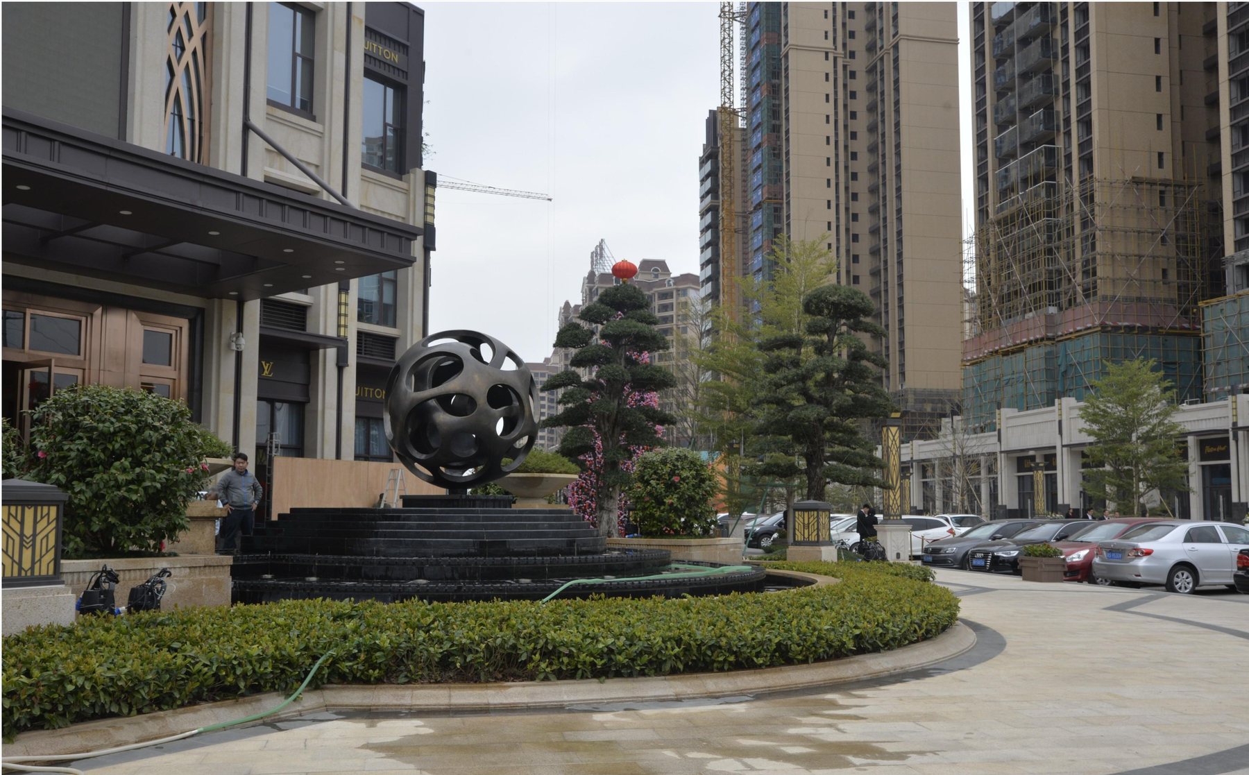 Dark spherical sculpture in the Mingju Shanshui City entrance landscape
