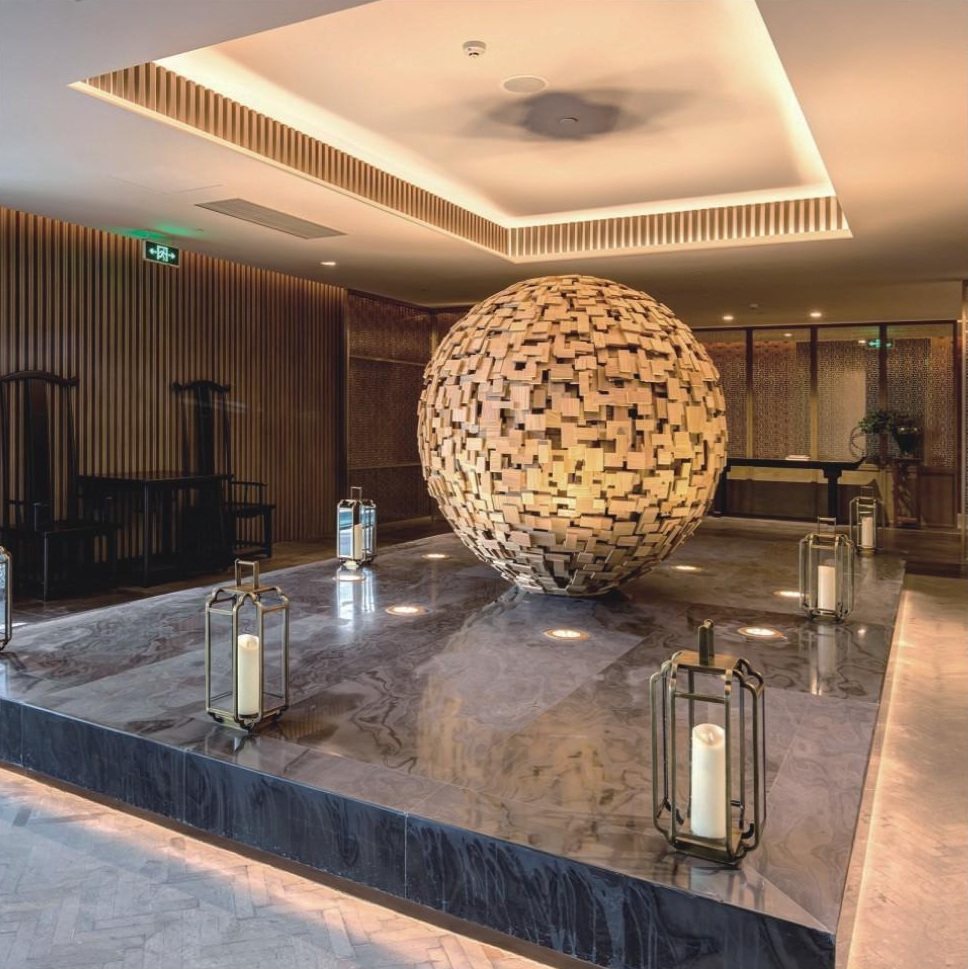 Large spherical artwork in a hotel circulation space