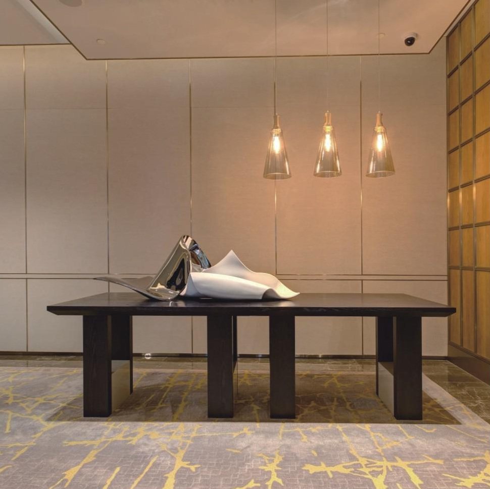 Black and white abstract sculptures on a long display table