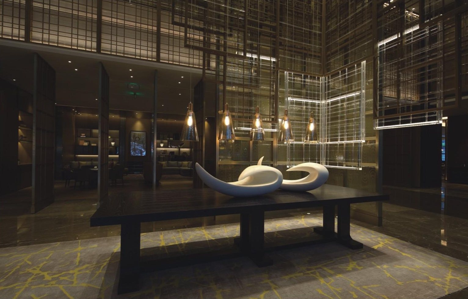 White abstract sculptures in a dark hotel lounge setting