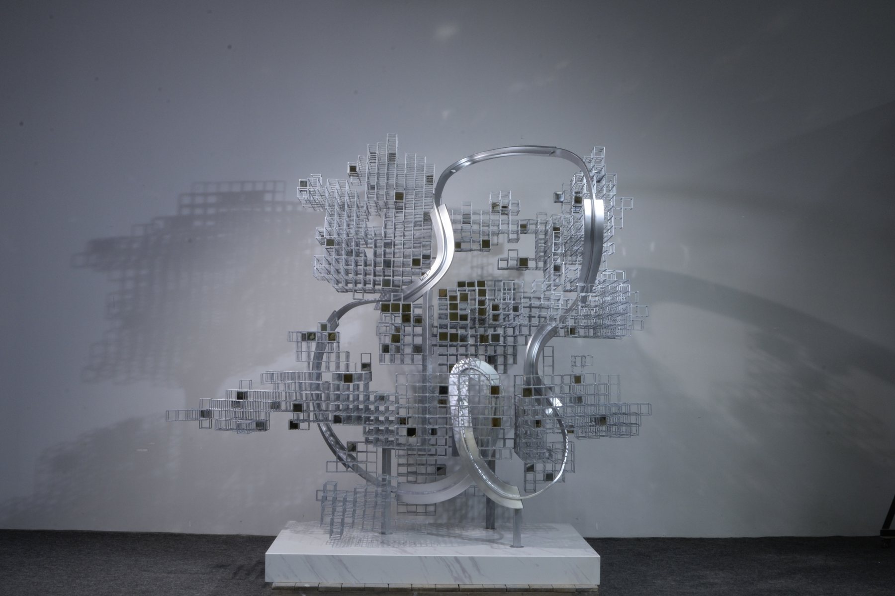 Layered grid sculpture with circular reflective elements