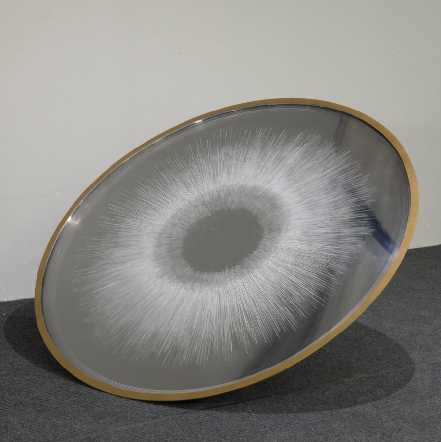 Reverse view showing a radiating center on the circular sculpture