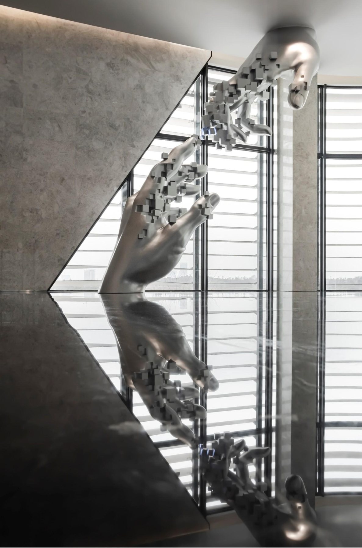 Oversized silver hand sculpture at Vanke Wanchuang Technology City