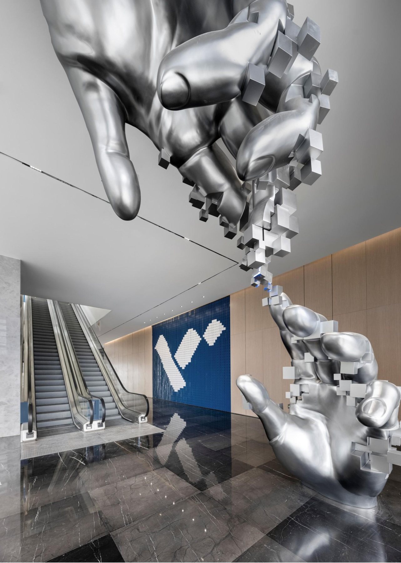 Pixel-like construction of the silver interior hand sculpture