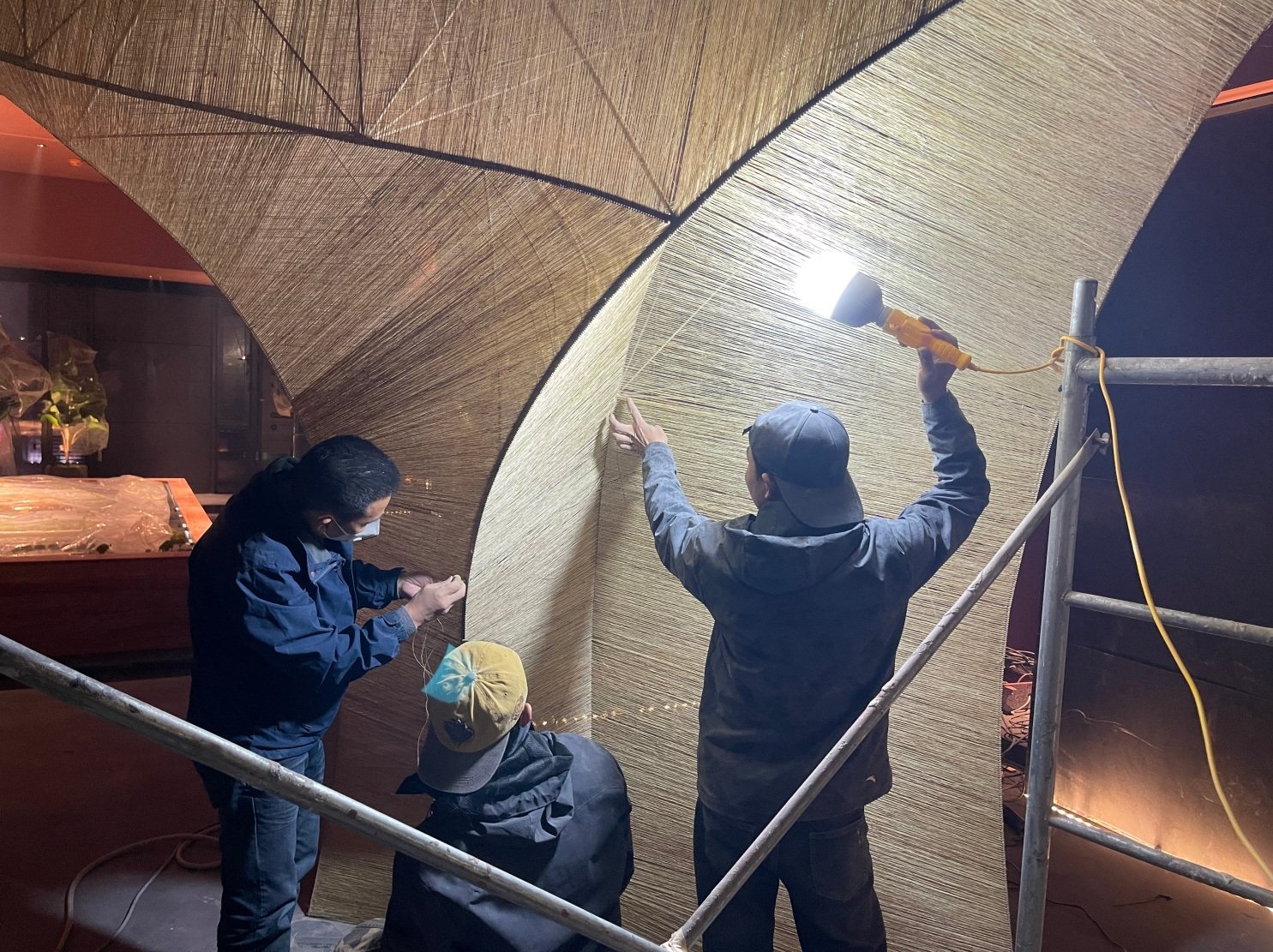 On-site installation of the woven surface over the frame