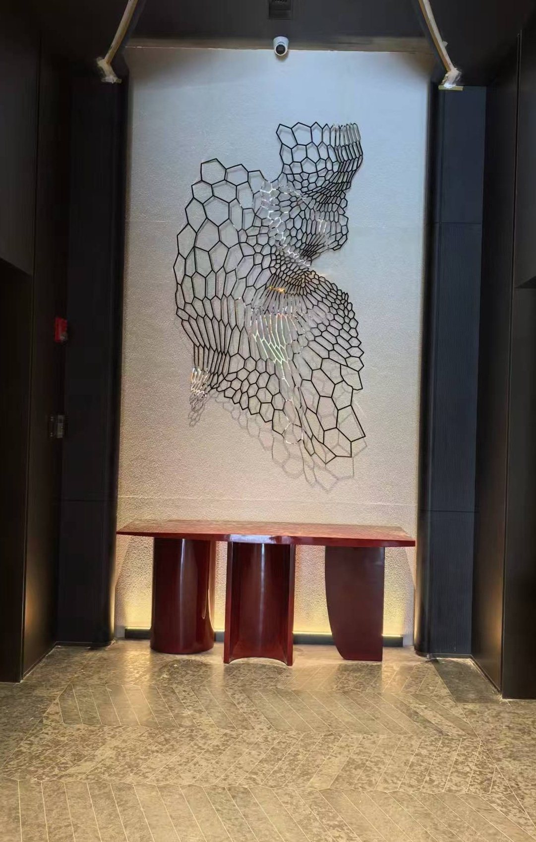 Wire-frame portrait artwork mounted on a hotel feature wall