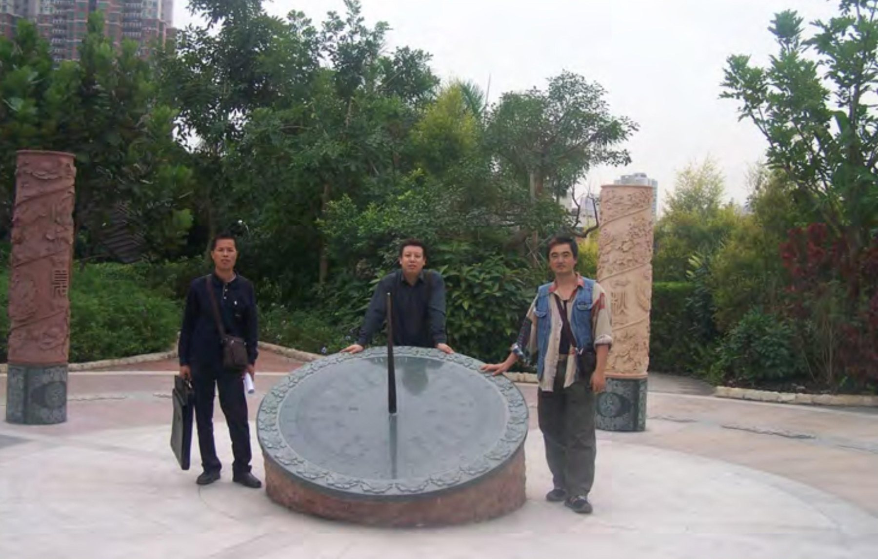 Circular feature and cultural columns in the park landscape