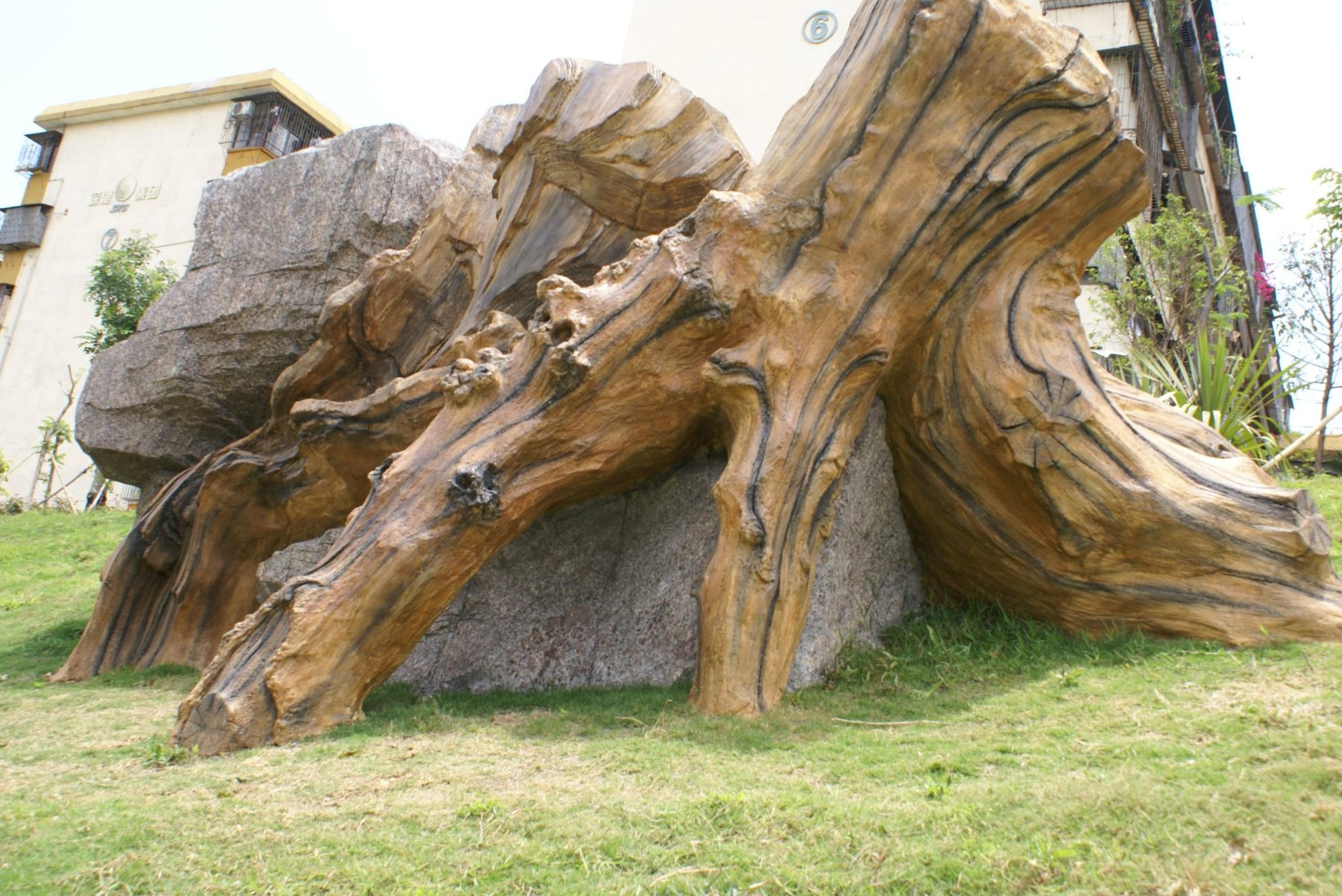 Large root-like landscape sculpture on a planted Shenzhen greenway slope
