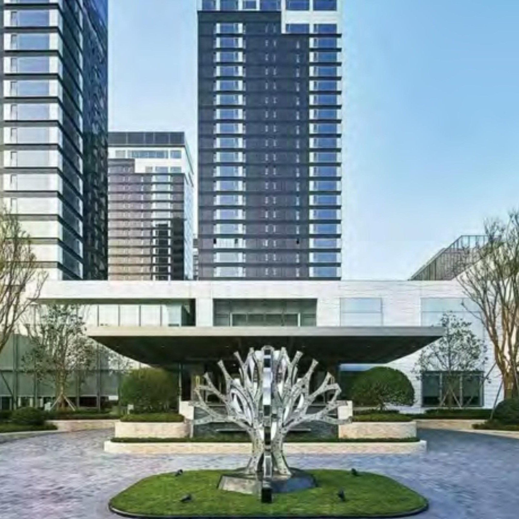 Illuminated tree-like sculpture in the residential landscape at night