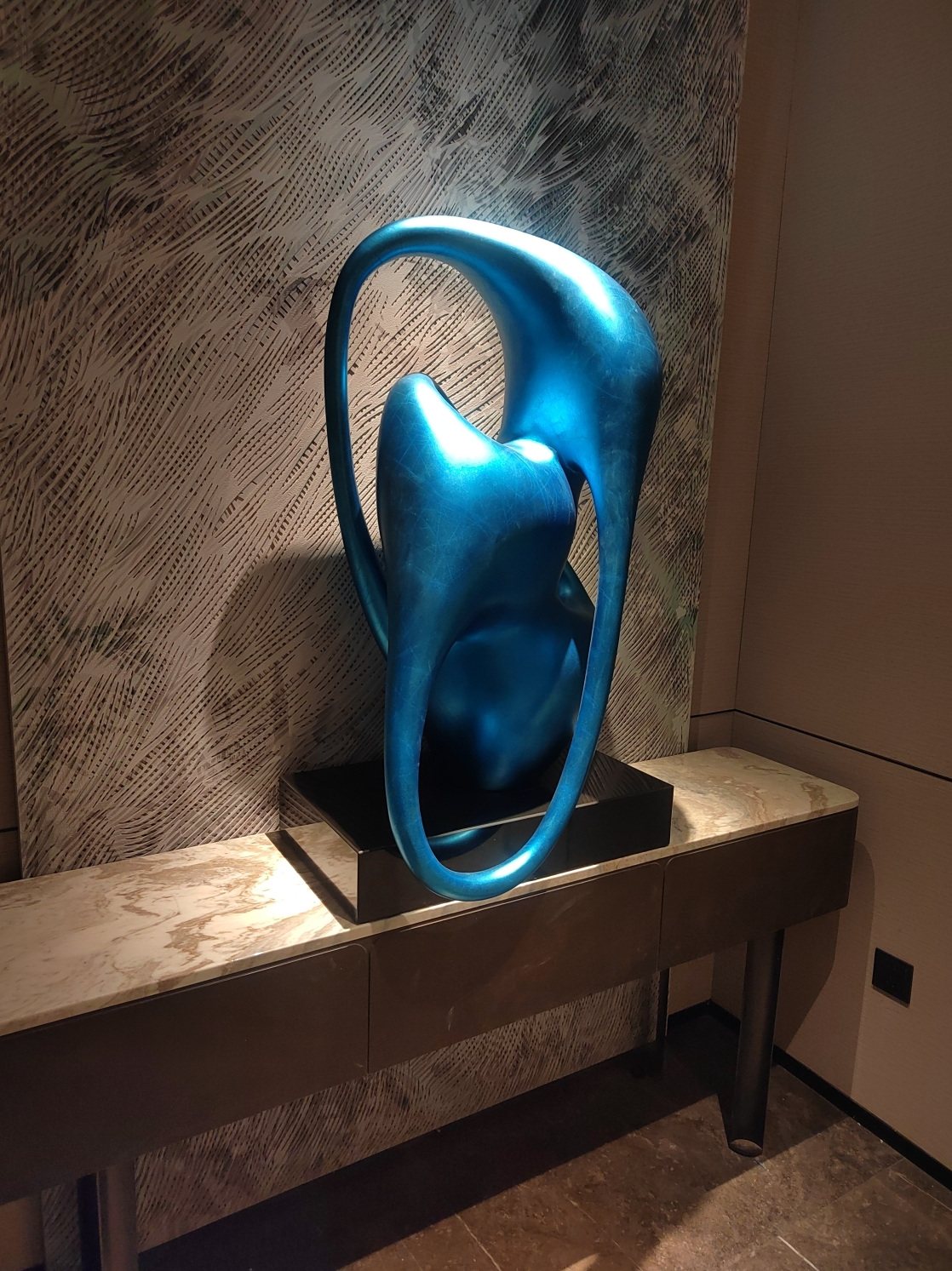 Blue abstract sculpture displayed on a console