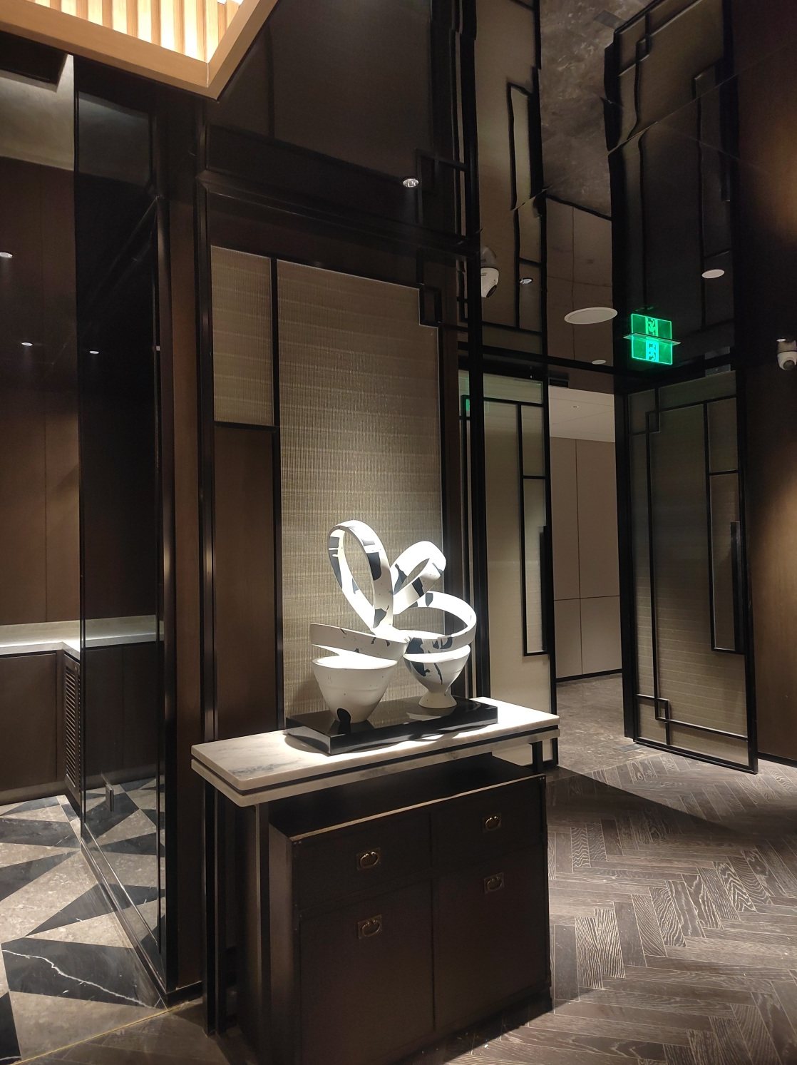 White abstract sculpture displayed in a hotel corridor