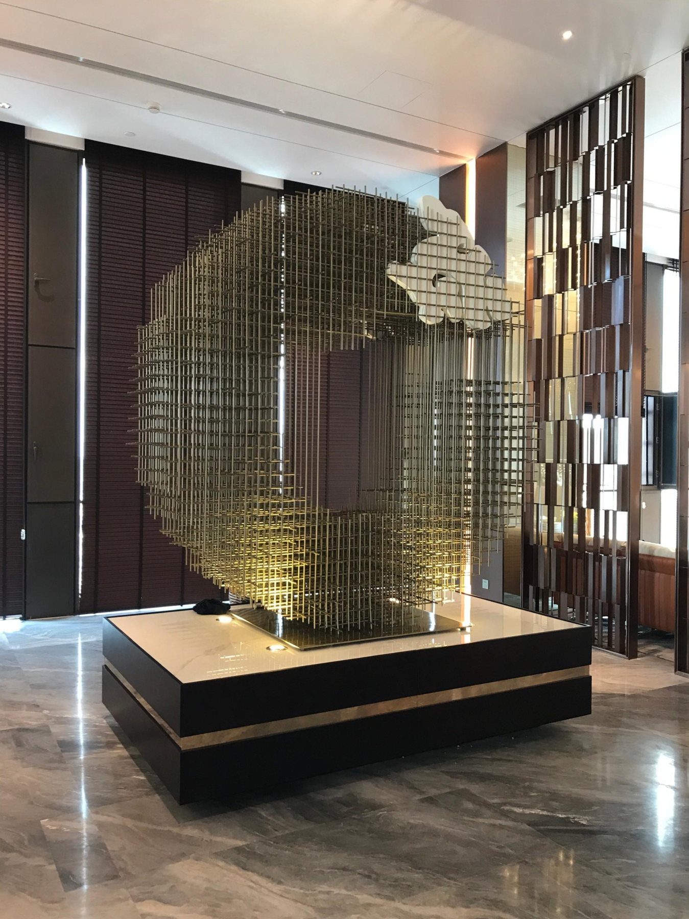 Side view through the open grid of the lobby artwork